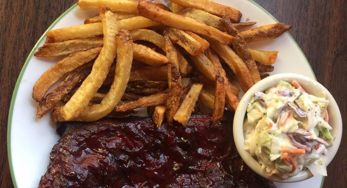 french fries, bbq meat, and coleslaw on a plate