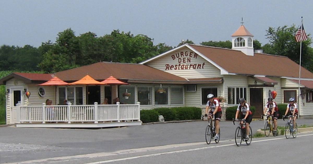 people riding bikes by a restaurant