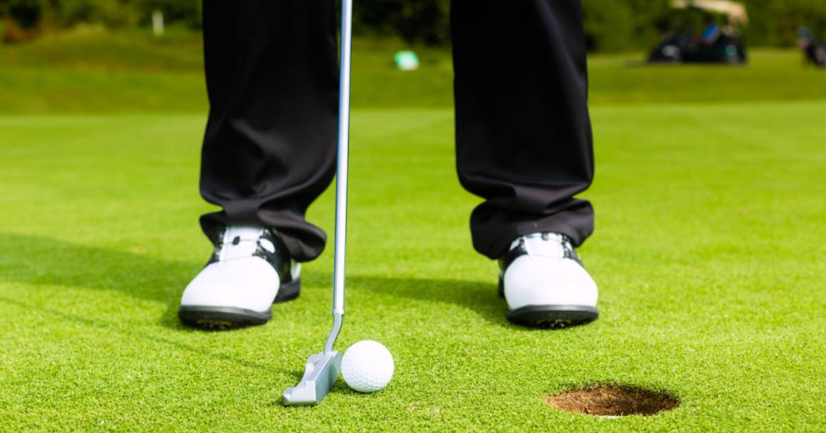 view of golfer preparing to putt the ball