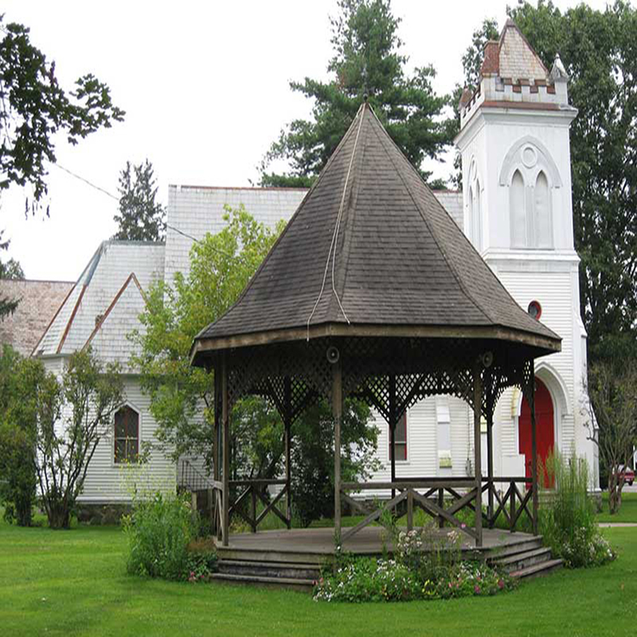 A Gazebo in front of a white church house in Greenwich, NY