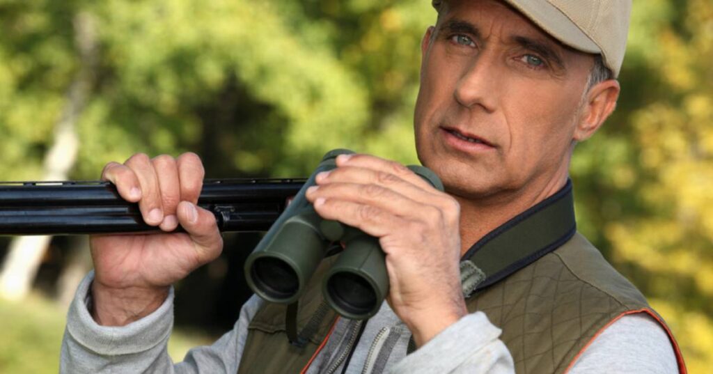 hunter with gun and binoculars