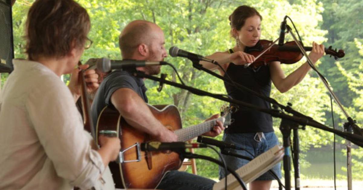 three musicians performing outdoors
