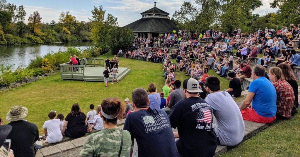 people watching an event in a park