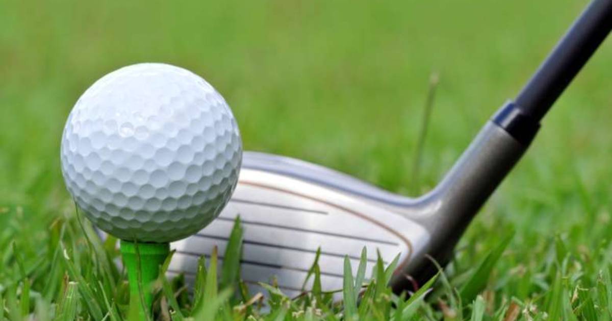 close up view of a golf ball and club