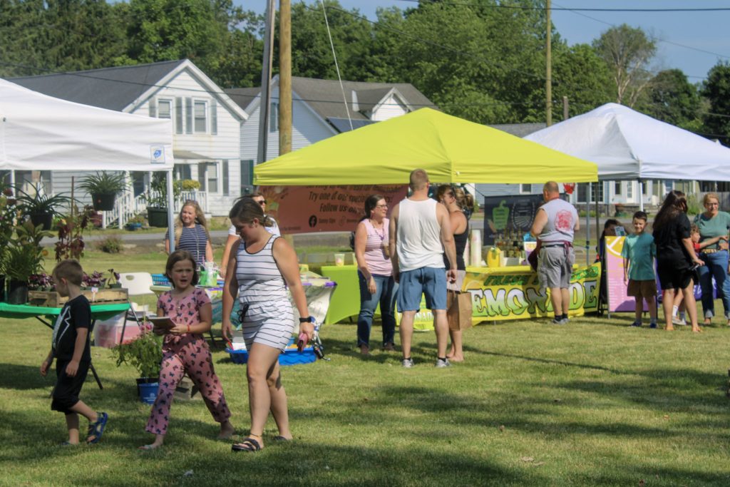 People enjoying Canal Street Marketplace, a farmers market in Fort Edward, NY